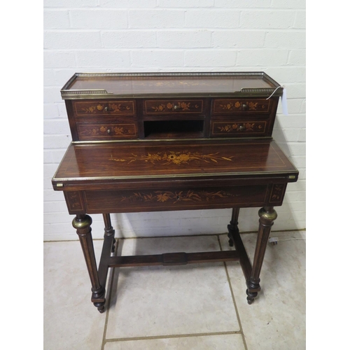 296 - A 19th century inlaid rosewood bonheur de jour with a brass gallery on five drawer upstand with a fo... 