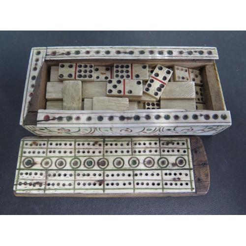 1218 - A French Prisoner of War bone domino set in bone carved box with cribbage set to top - in fair condi... 