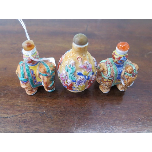 1242 - Three Oriental snuff bottles two in the form of elephants - all three bottles in good condition