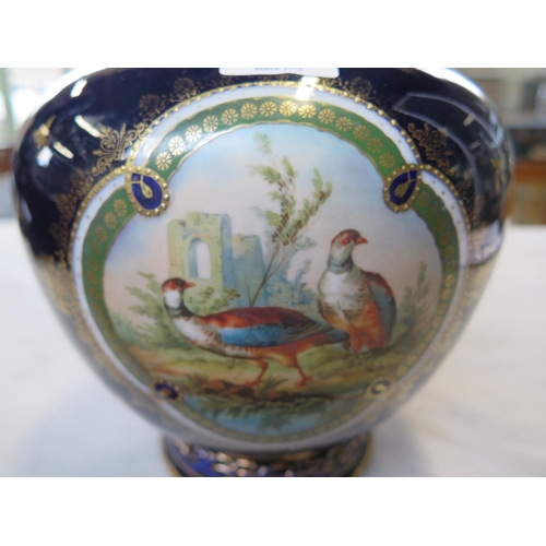 1245 - A Vienese vase with cobalt blue and gilt field decorated with a panel depicting game birds amongst r... 