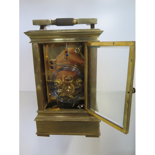 201 - A good quality brass carriage clock striking on a gong and bells with repeat with a gilt dial and fr... 