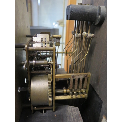 209 - An 8 day longcase clock in an oak case with quarter Westminster chimes