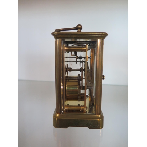 218 - A brass carriage clock - Height 12cm - ticks but stops