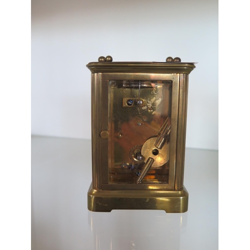 218 - A brass carriage clock - Height 12cm - ticks but stops