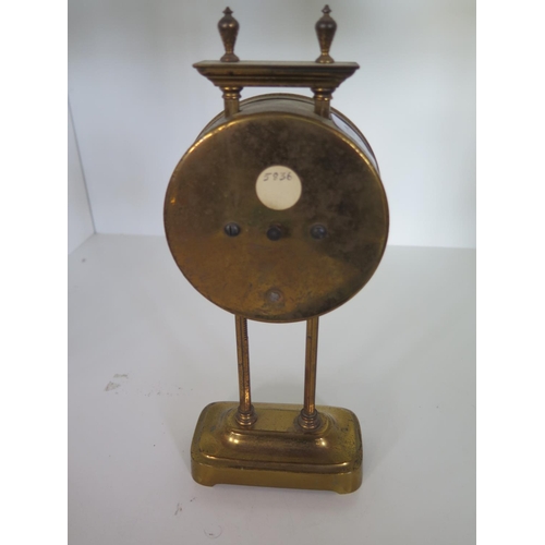 225 - A brass gravity action mantle clock - Height 25cm - not working