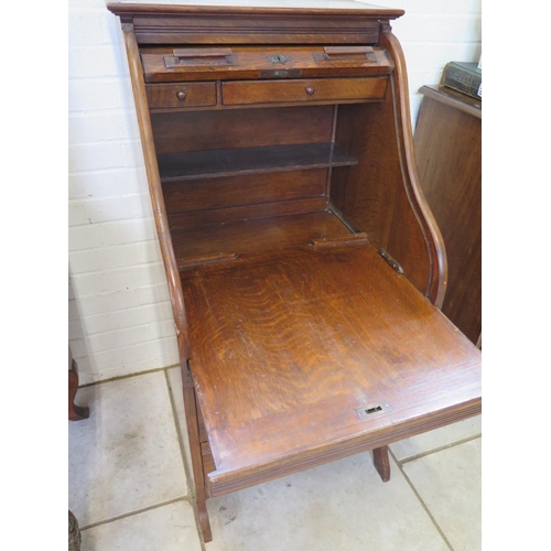 262 - An unusual oak roll top desk with two small drawers to interior above a slide and two base drawers -... 