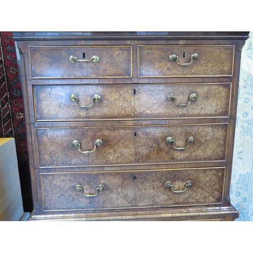 266 - An 18th century burr walnut chest on chest with a brushing slide and canted corners raised on bracke... 