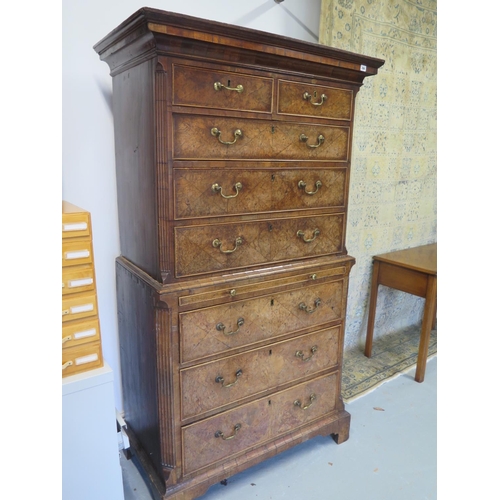 266 - An 18th century burr walnut chest on chest with a brushing slide and canted corners raised on bracke... 