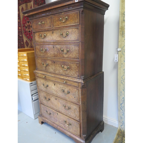 266 - An 18th century burr walnut chest on chest with a brushing slide and canted corners raised on bracke... 