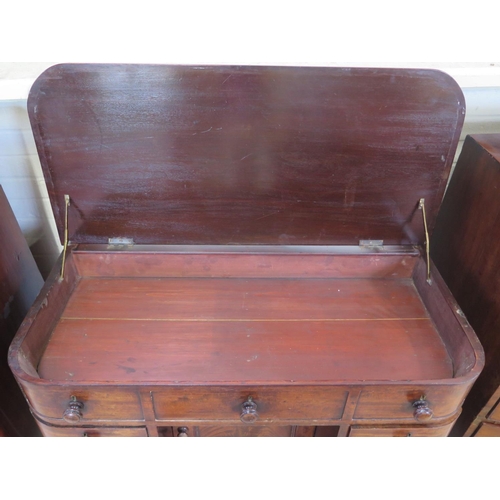 267 - A Victorian D shaped knee hole desk with a lift up top above three dummy drawers with a central cupb... 