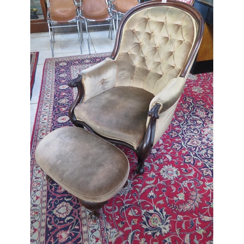 269 - A 19th century mahogany button back scroll armchair with a similar footstool