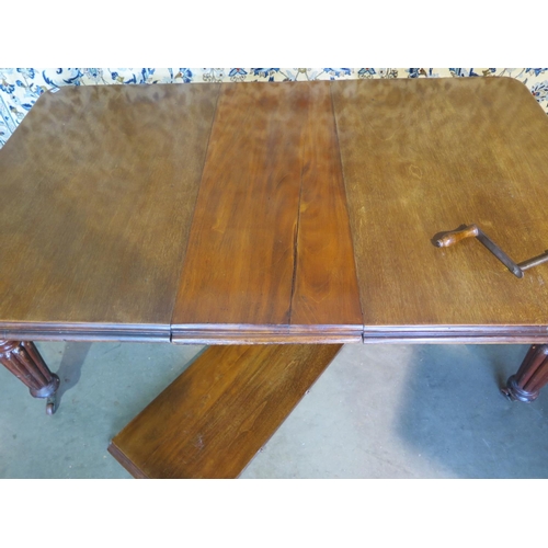 289 - A 19th century mahogany wind out dining table with two leaves extending from 143cm to 222cm with the... 