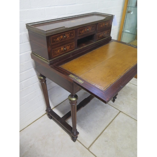 296 - A 19th century inlaid rosewood bonheur de jour with a brass gallery on five drawer upstand with a fo... 