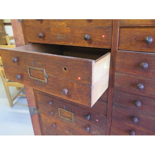 305 - A late 19th century oak museum shop cabinet with a series of 16 small drawers and seven double drawe... 