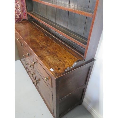 310 - A good Georgian oak dresser with a good patina, the open rack top above an arrangement of six drawer... 