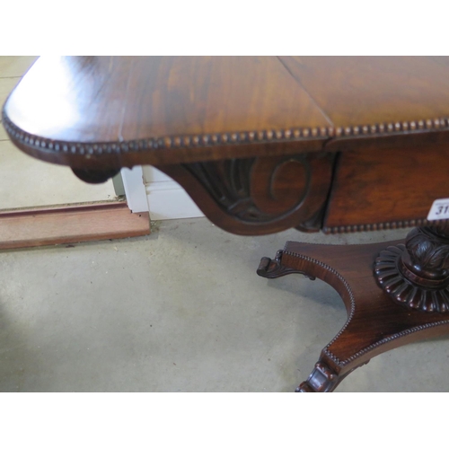 316 - A 19th century rosewood sofa table with drop end flaps on a carved column and quatrefoil platform ba... 