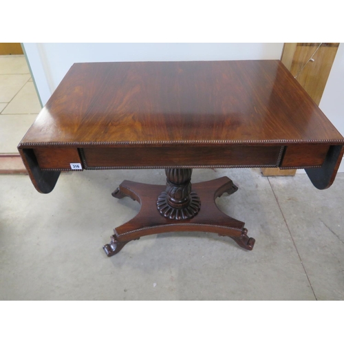 316 - A 19th century rosewood sofa table with drop end flaps on a carved column and quatrefoil platform ba... 