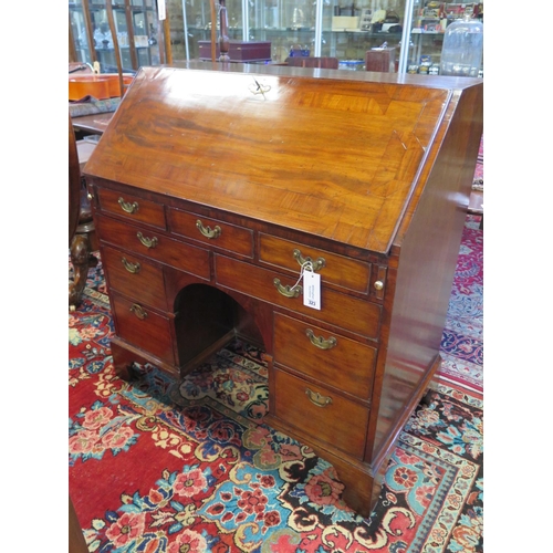 323 - A Georgian mahogany kneehole bureau with a fitted interior of candle slides, drawers and pigeon hole... 