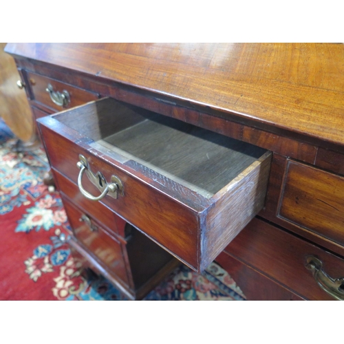 323 - A Georgian mahogany kneehole bureau with a fitted interior of candle slides, drawers and pigeon hole... 