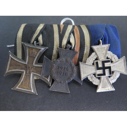 504 - A group of three German Medals including a WWI Iron Cross 2nd Class, a 1914-18 German Honour Medal a... 