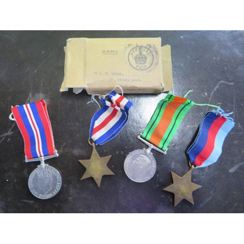 514 - Four unnamed WWII medals and a box