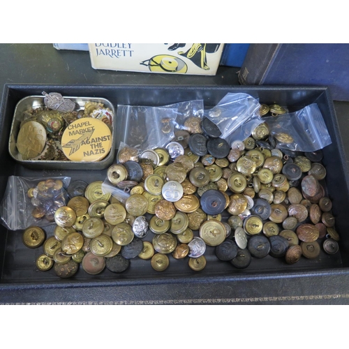 535 - A collection of military badges and buttons together with a 1st edition copy of British Naval Dress ... 