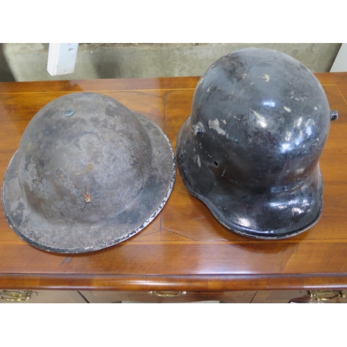 559 - A German helmet dating from WWI and a British tin helmet