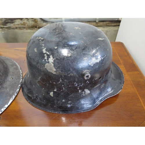 559 - A German helmet dating from WWI and a British tin helmet