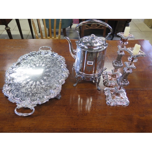 669 - A pair of ornate Sheffield plate candlesticks and a plated tea kettle on stand with spirit burner an... 