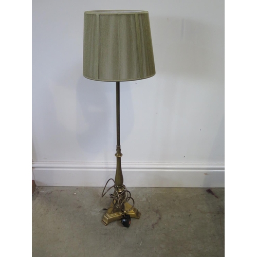 67 - A brass lamp with triangular weighted base - approx height 84cm with shade