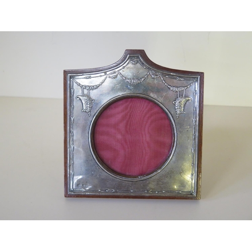 680 - A silver hallmarked picture frame with embossed decoration and central circular aperture Birmingham ... 