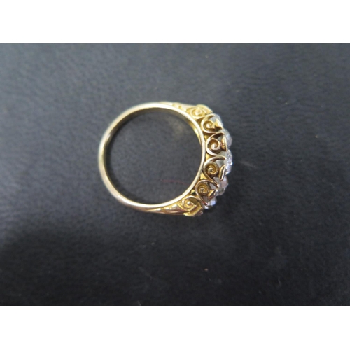 751 - A yellow gold five stone diamond ring with ten smaller diamonds set to the outer edge - ring size P ... 