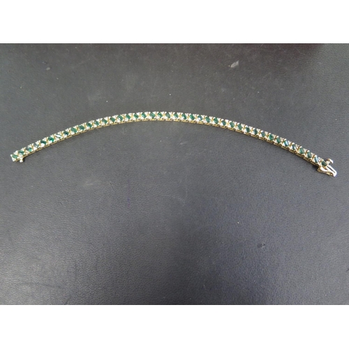 755 - A 14ct yellow gold emerald bracelet set with small diamonds - Length 18cm - approx weight 12.8 grams... 