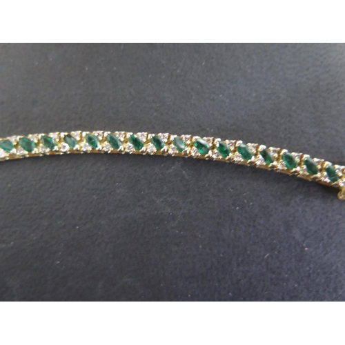 755 - A 14ct yellow gold emerald bracelet set with small diamonds - Length 18cm - approx weight 12.8 grams... 