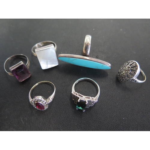 769 - Six silver rings, various sizes and design - turquoise, red paste, marcasite, green paste, amethyst ... 