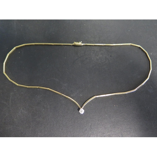 776 - An 18ct yellow gold marked 750 link necklace with single diamond set to center - diamond weight appr... 