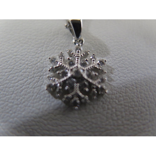 824 - A white gold and diamond snow flake pendant - total diamond weight approx 0.31ct - on a 45cm chain -... 