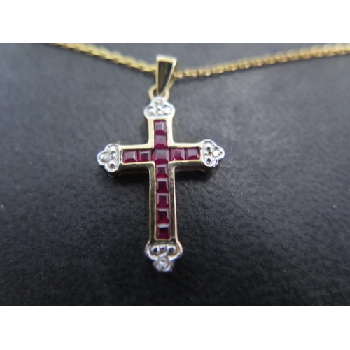 847 - A 9ct yellow gold crucifix set with square cut rubies and diamonds on a 9ct gold chain - total appro... 