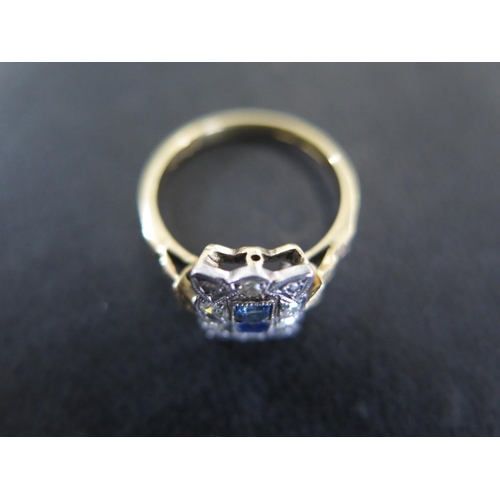 852 - An 18ct yellow gold and platinum diamond and sapphire ring size L - the two central square cut sapph... 