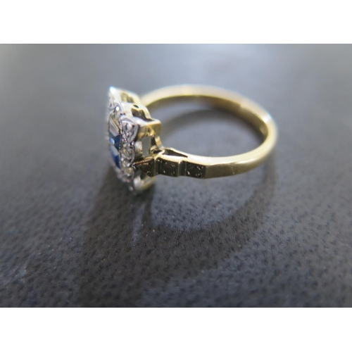 852 - An 18ct yellow gold and platinum diamond and sapphire ring size L - the two central square cut sapph... 