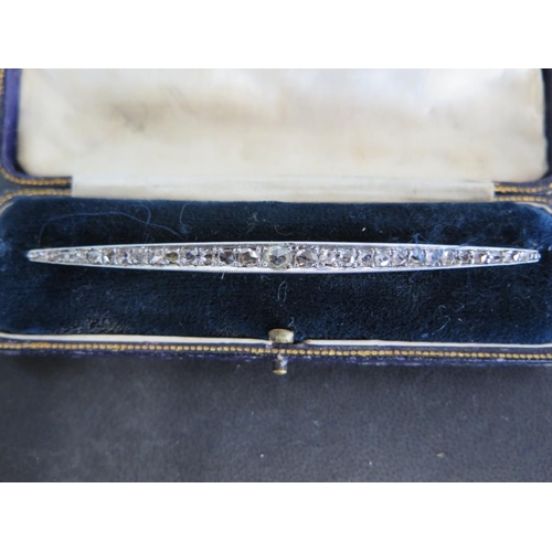 858 - An Art Deco design yellow gold and white gold bar brooch set with 29 diamonds, graduated in size fro... 