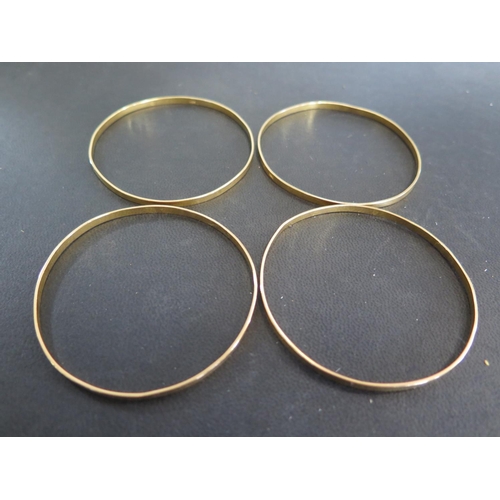 867 - Four 21ct yellow gold bangles - approx weight 31.3 grams - all clean and bright, one slightly bent