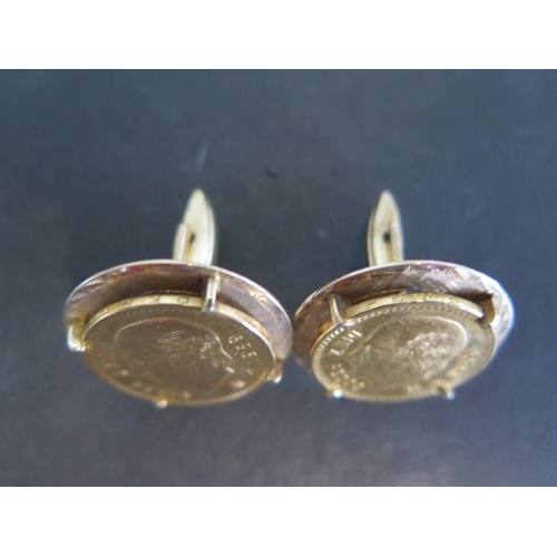 871 - A pair of 14ct yellow gold cuff links both with a Mexican 22ct yellow gold diez Pesos coin to upper ... 