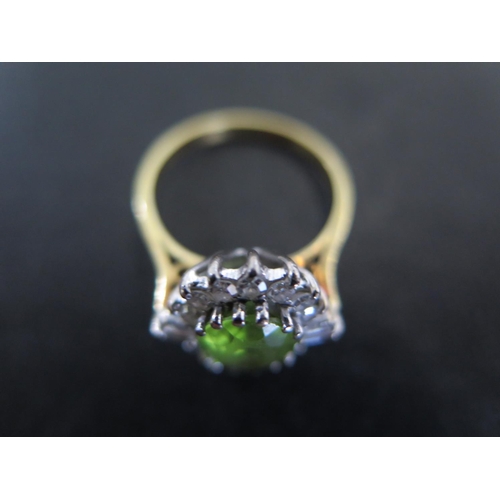 872 - An 18ct yellow gold peridot diamond cluster ring size N - approx weight 3.7 grams - some usage wear,... 