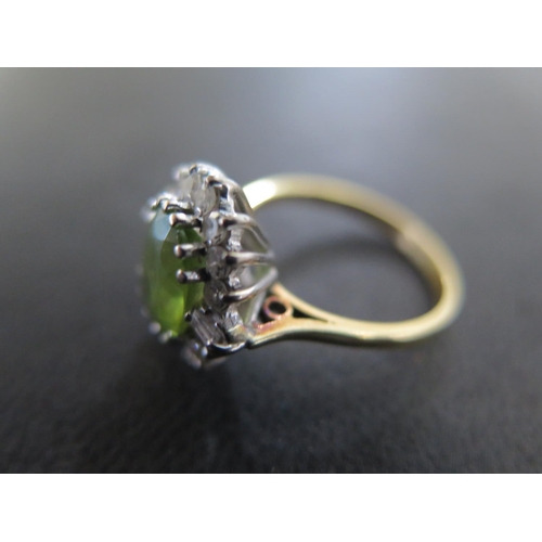 872 - An 18ct yellow gold peridot diamond cluster ring size N - approx weight 3.7 grams - some usage wear,... 