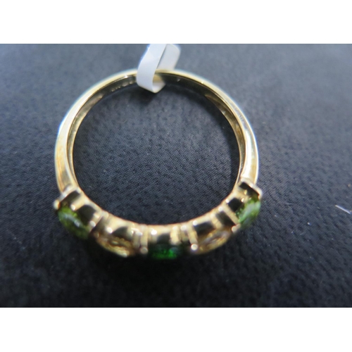 873 - A 9ct yellow gold peridot and tsavorite ring size R - approx weight 2.1 grams - in good condition