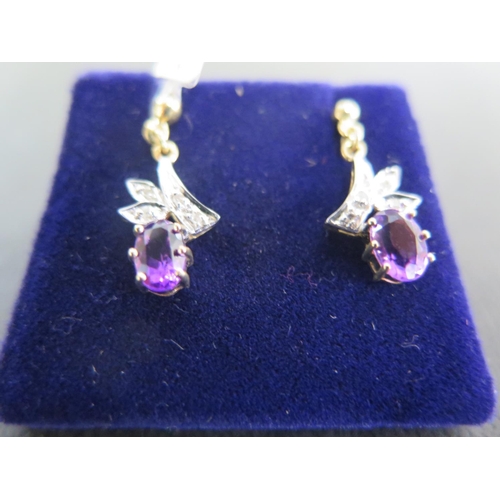 875 - A pair of 9ct yellow gold amethyst and diamond drop earrings - in good condition