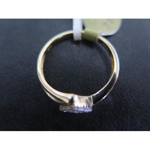 876 - A 9ct yellow gold ring set with nine round cut diamonds totaling 0.1ct - ring size R - approx weight... 