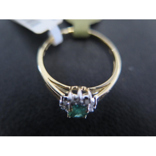 883 - A 9ct yellow gold emerald and diamond ring size P - approx weight 1.5 grams - some light surface scr... 