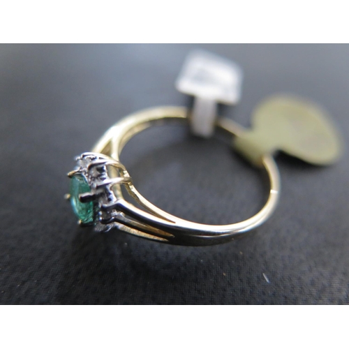 883 - A 9ct yellow gold emerald and diamond ring size P - approx weight 1.5 grams - some light surface scr... 